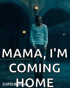 A Man In A White Shirt Is Standing In Front Of A Tunnel And Says Mama I 'M Coming Home . GIF