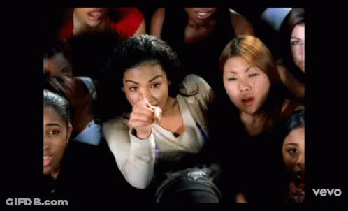A Man In A White Shirt Is Standing In Front Of A Window With The Word Vevo On The Bottom Of The Screen GIF