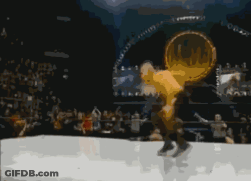 A Man In A White Shirt Is Standing In Front Of Another Man In A Boxing Ring GIF