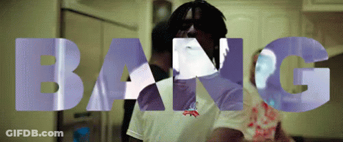 A Man In A White Shirt Is Standing In Front Of The Words Bang GIF