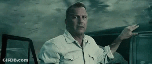 A Man In A White Shirt Is Standing Next To A Car In The Dark . GIF