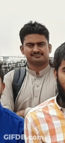 A Man In A White Shirt Is Standing Next To Another Man In A Plaid Shirt GIF