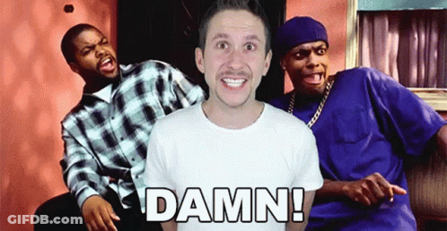 A Man In A White Shirt Is Surrounded By Two Men And The Word Damn Is On The Front Of His Shirt GIF