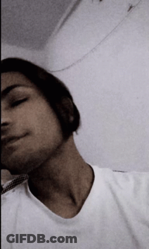 A Man In A White Shirt Is Taking A Picture Of Himself GIF