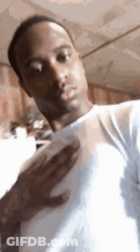 A Man In A White Shirt Is Taking A Picture Of Himself . GIF