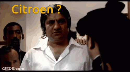 A Man In A White Shirt Is Talking To Another Man With The Word Citroen Written On The Screen GIF