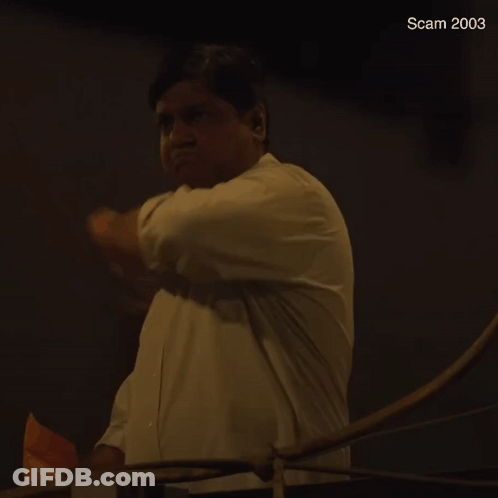 A Man In A White Shirt Is Throwing A Piece Of Paper In The Air And The Year 2003 Is Visible In The Corner GIF