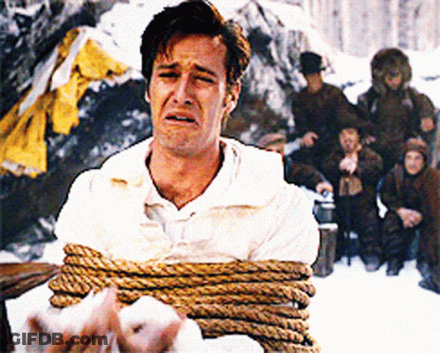 A Man In A White Shirt Is Tied Up With Rope And Crying GIF