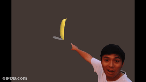 A Man In A White Shirt Points To A Banana GIF