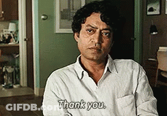 A Man In A White Shirt Says Thank You In A Room GIF