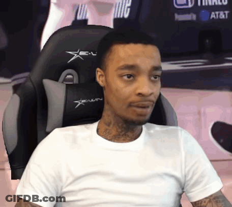 A Man In A White Shirt Sits In A Gaming Chair GIF