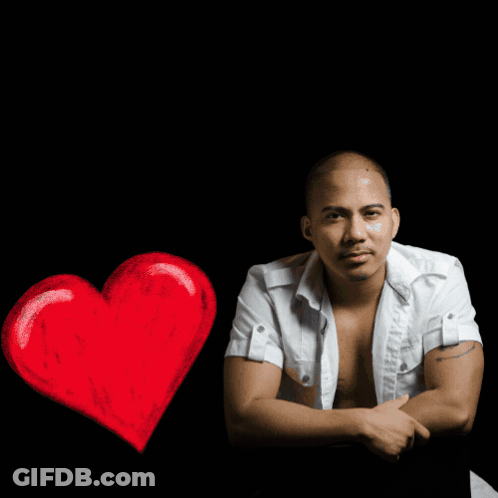 A Man In A White Shirt Sits In Front Of A R & R Music House Logo GIF