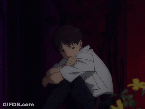 A Man In A White Shirt Sits With His Head Down GIF