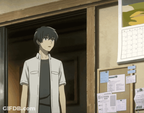 A Man In A White Shirt Stands In Front Of A Bulletin Board GIF