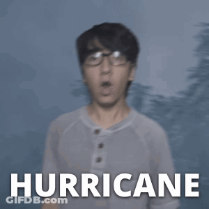 A Man In A White Shirt Stands In Front Of A Hurricane GIF