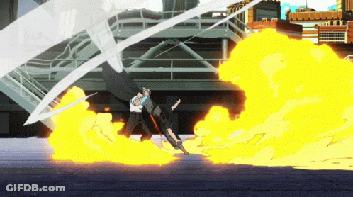 A Man In A White Shirt Stands In Front Of A Large Fire GIF
