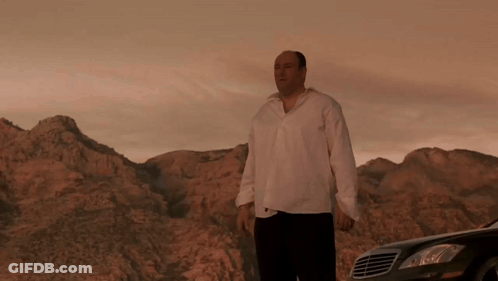 A Man In A White Shirt Stands In Front Of A Mercedes GIF