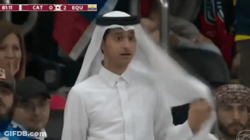 A Man In A White Shirt Stands In Front Of A Scoreboard That Says Equ GIF