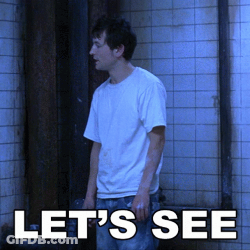A Man In A White Shirt Stands In Front Of A Tiled Wall With The Words Let 'S See Above Him GIF