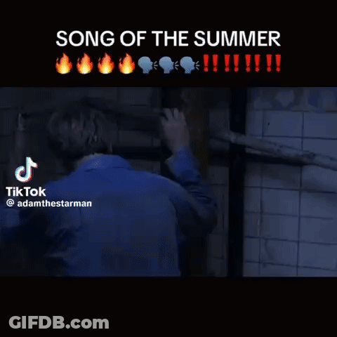 Man In White Shirt In Front Of Tiled Wall GIF