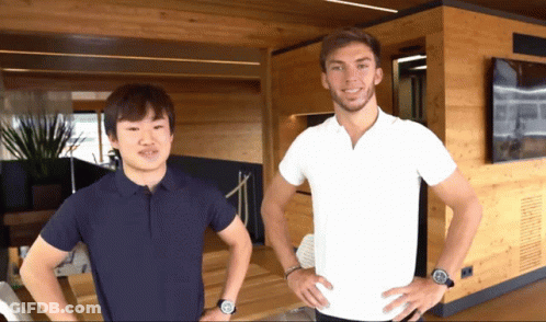 A Man In A White Shirt Stands Next To Another Man In A Black Shirt GIF