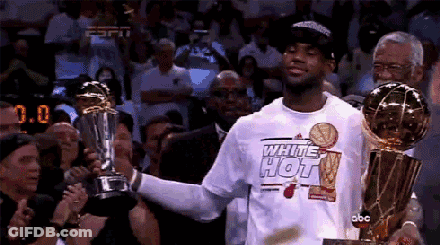 A Man In A White Shirt That Says White Hot Holds A Trophy GIF