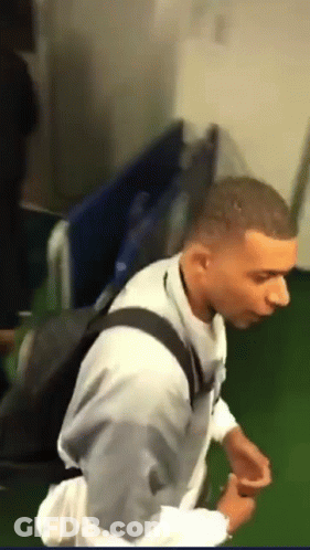 A Man In A White Shirt With A Black Backpack GIF