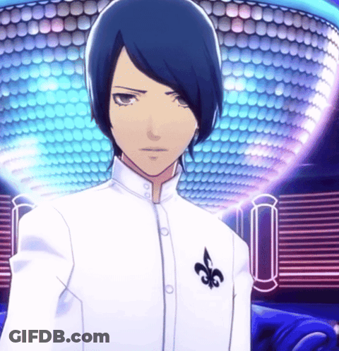 A Man In A White Shirt With A Black Fleur De Lis On His Chest GIF