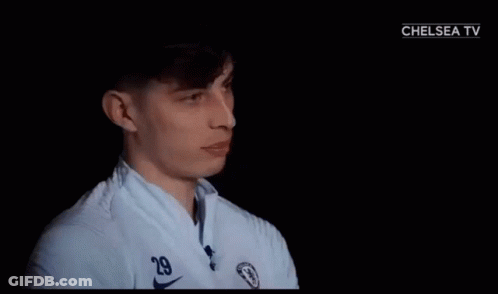 A Man In A White Shirt With A Chelsea Logo On It GIF