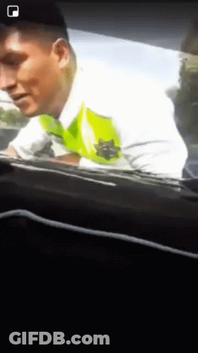 A Man In A White Shirt With A Green Star On It GIF