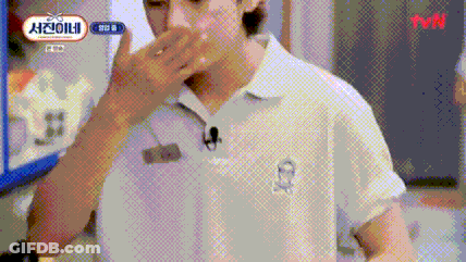 A Man In A White Shirt With A Microphone On His Neck Is Covering His Mouth . GIF