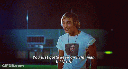 A Man In A White Shirt With A Picture Of A Man On It Says You Just Gotta Keep On Livin ' GIF