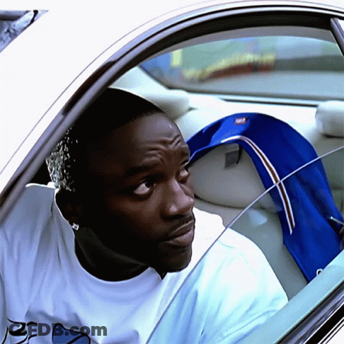 A Man In A White Shirt With The Letter R On It Is Sitting In A Car GIF