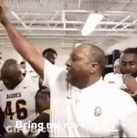 A Man In A White Shirt With The Number 46 On It Is Raising His Arms In The Air GIF