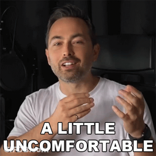 A Man In A White Shirt With The Words A Little Uncomfortable Above Him GIF