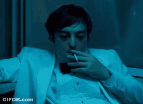 A Man In A White Suit And Black Bow Tie GIF