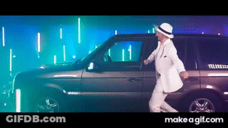 A Man In A White Suit And Hat Is Dancing In Front Of A Car GIF