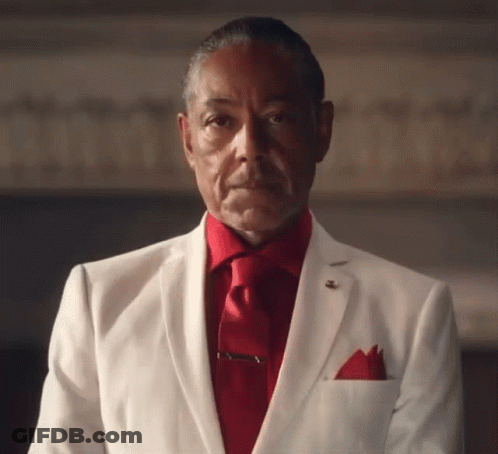 A Man In A White Suit And Red Tie Has A Pocket Square In His Pocket GIF
