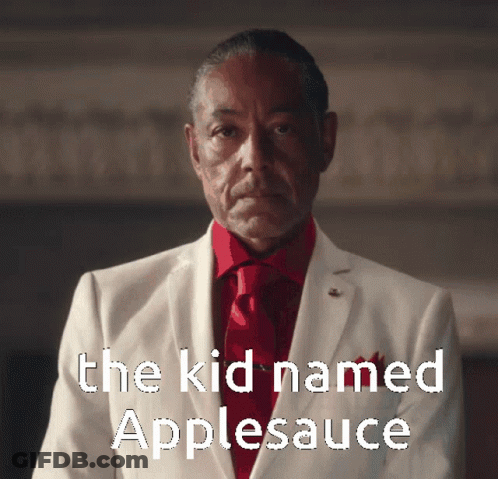 A Man In A White Suit And Red Tie With The Words " The Kid Named Applesauce " Above Him GIF