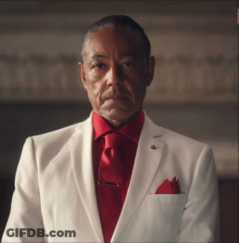 A Man In A White Suit Has A Red Tie GIF