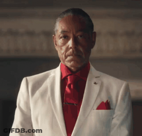 A Man In A White Suit Has A Red Tie GIF