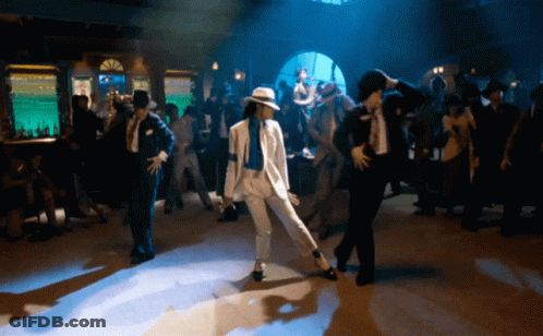Man In White Suit Dancing In Dark Room GIF