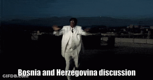 A Man In A White Suit Is Dancing With The Words Bosnia And Herzegovina Discussion Behind Him GIF