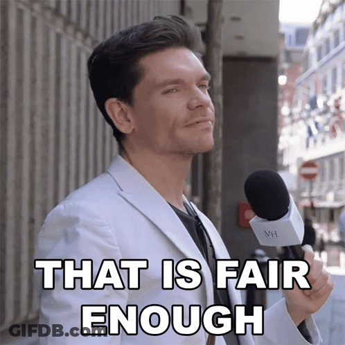 A Man In A White Suit Is Holding A Microphone And Says " That Is Fair Enough " GIF
