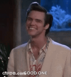 A Man In A White Suit Is Smiling And Says `` Good One '' . GIF