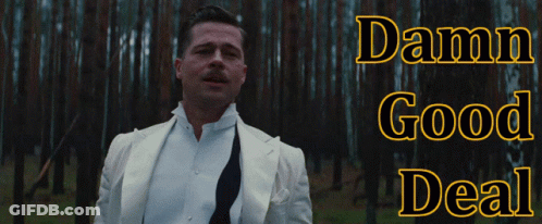 A Man In A White Suit Is Standing In A Forest With The Words Damn Good Deal Above Him GIF