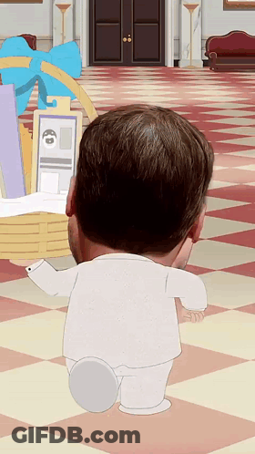 A Man In A White Suit Is Standing In Front Of A Basket With A Blue Bow On It GIF