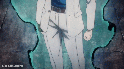 A Man In A White Suit Is Standing In Front Of A Green Wall GIF