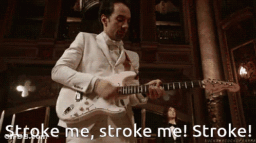 A Man In A White Suit Playing A Guitar With The Words Stroke Me Stroke Me Stroke GIF