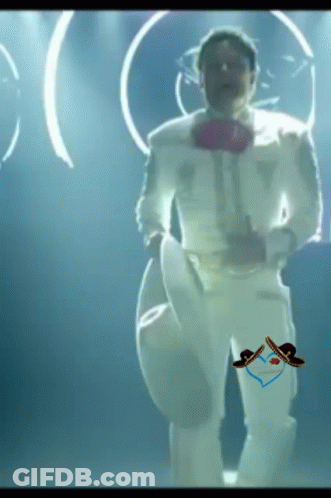 A Man In A White Suit With A Sombrero On His Pants Is Dancing GIF